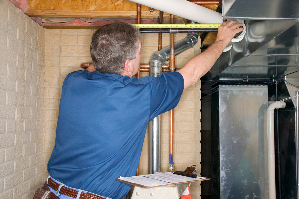 Handyman inspecting pipes