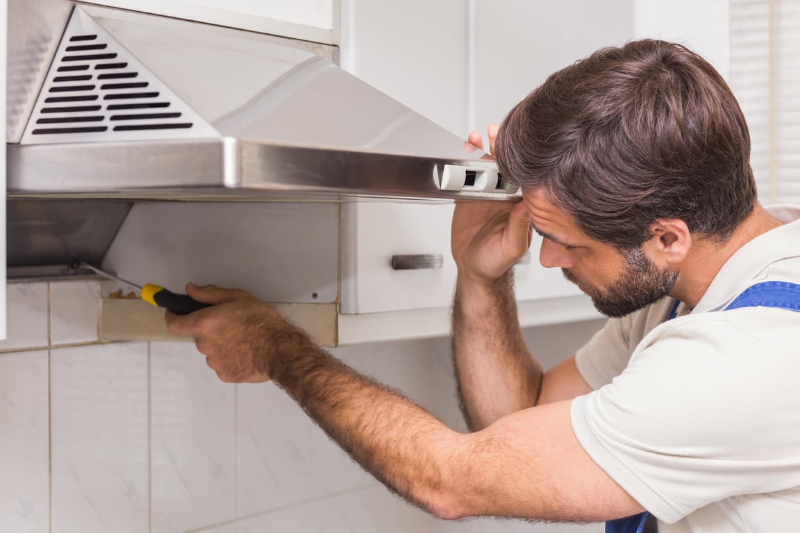 Handyman fixing the oven